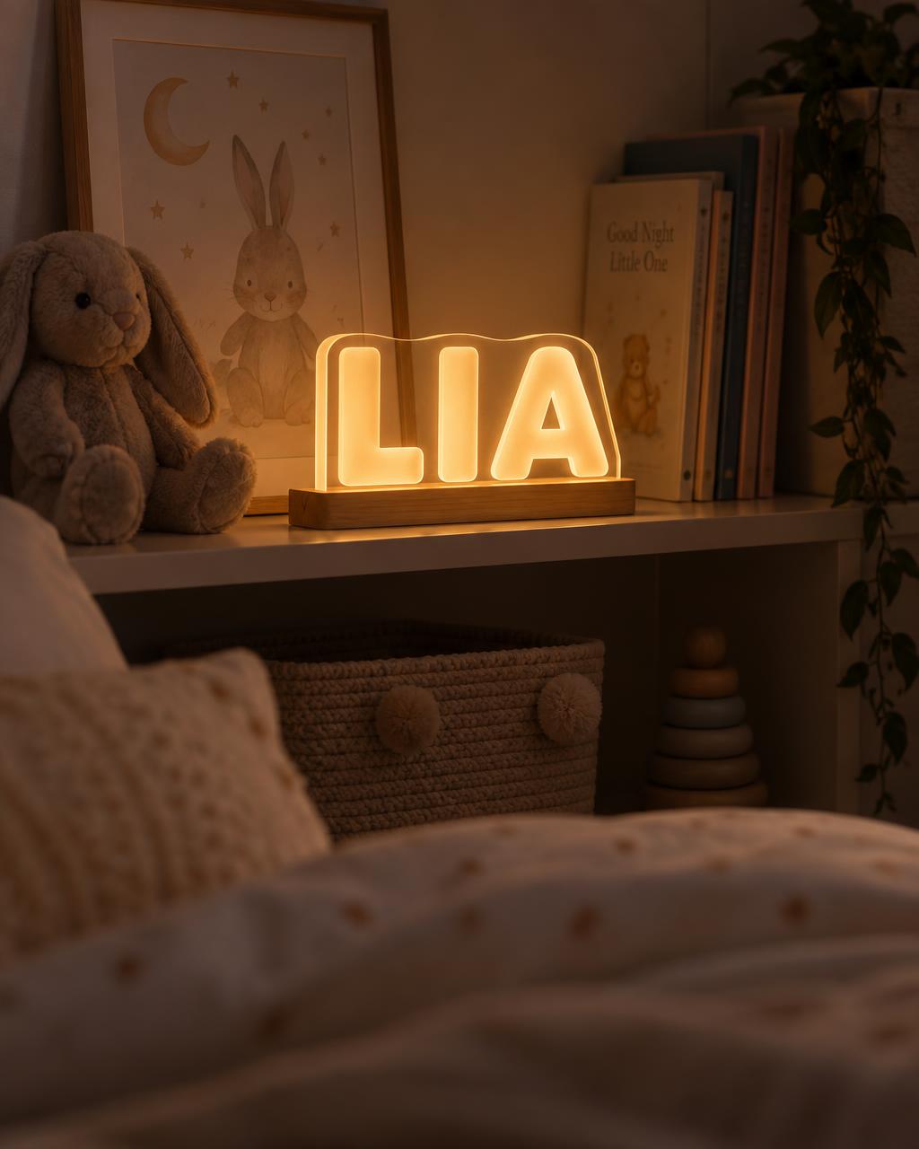 A glowing name night light spelling LIA on a child's bedroom shelf